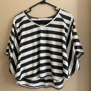 This is a black and white striped large “Rewind” shirt.